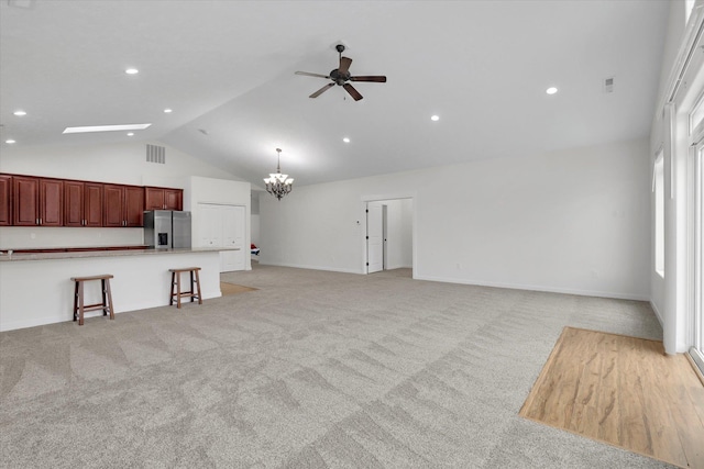 403 N Calvin Ln, Spokane Valley, WA 99216 - unfurnished living room with lofted ceiling, a ceiling fan, a chandelier, light colored carpet, and recessed lighting