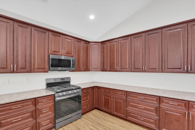 403 N Calvin Ln, Spokane Valley, WA 99216 - kitchen featuring appliances with stainless steel finishes, vaulted ceiling, light wood-style flooring, recessed lighting, and light stone counters