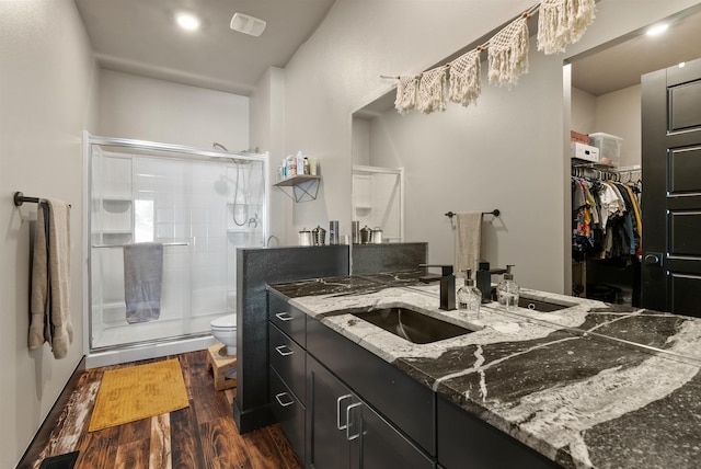 3228 N Mckinnon Rd, Spokane, WA 99217 - bathroom with vanity, wood finished floors, a stall shower, and a walk in closet