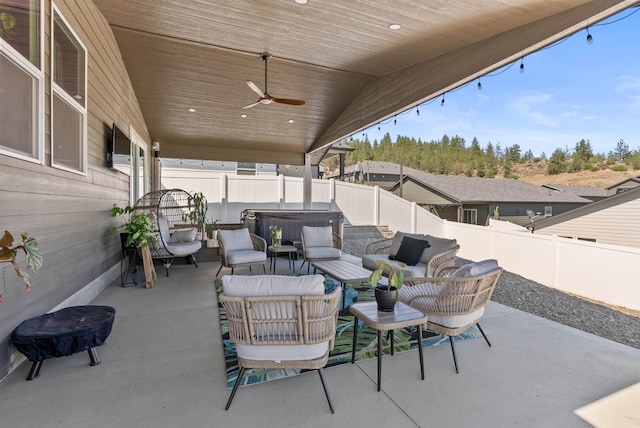 3228 N Mckinnon Rd, Spokane, WA 99217 - fenced backyard with a hot tub, a patio, outdoor lounge area, and a ceiling fan