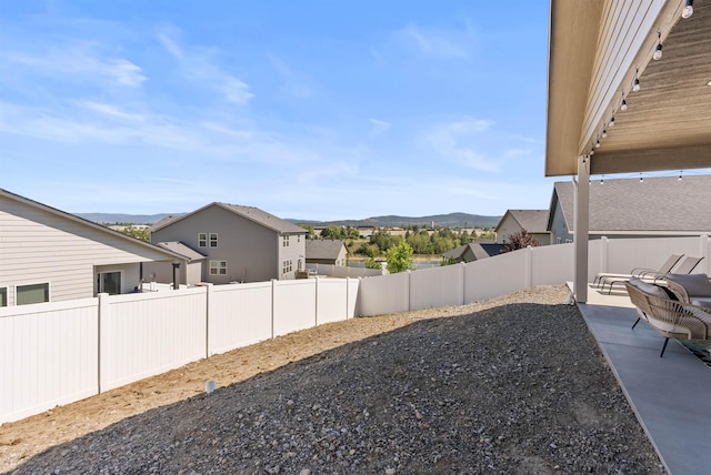 3228 N Mckinnon Rd, Spokane, WA 99217 - fenced backyard with a mountain view, a patio area, and a residential view