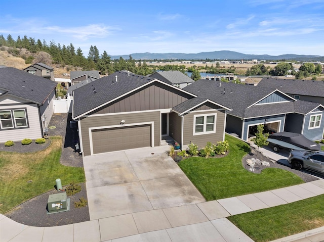3228 N Mckinnon Rd, Spokane, WA 99217 - view of front of house with board and batten siding, an attached garage, concrete driveway, and a residential view