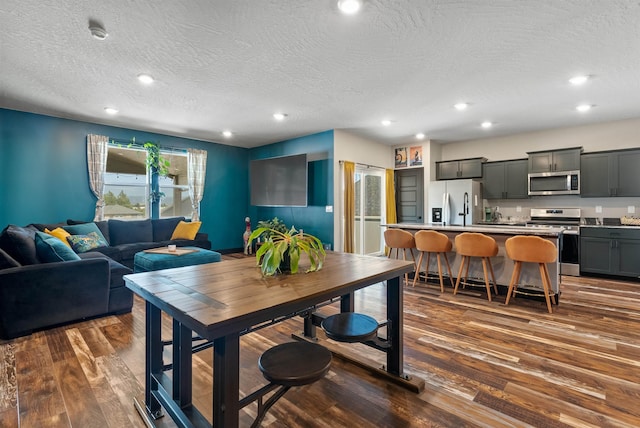 3228 N Mckinnon Rd, Spokane, WA 99217 - dining space featuring dark wood finished floors, a textured ceiling, and recessed lighting