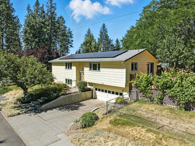 3832 S Cook St, Spokane, WA 99223 - bi-level home featuring driveway, solar panels, and an attached garage