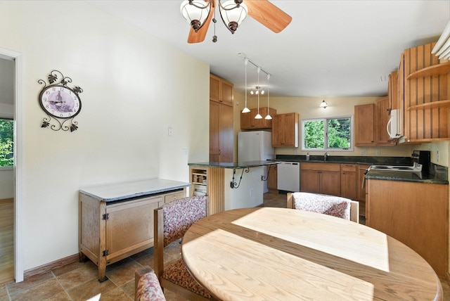 3832 S Cook St, Spokane, WA 99223 - kitchen with white appliances, open shelves, dark countertops, decorative light fixtures, and ceiling fan
