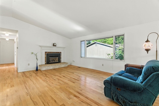3832 S Cook St, Spokane, WA 99223 - living area with vaulted ceiling, light wood-style flooring, and a fireplace