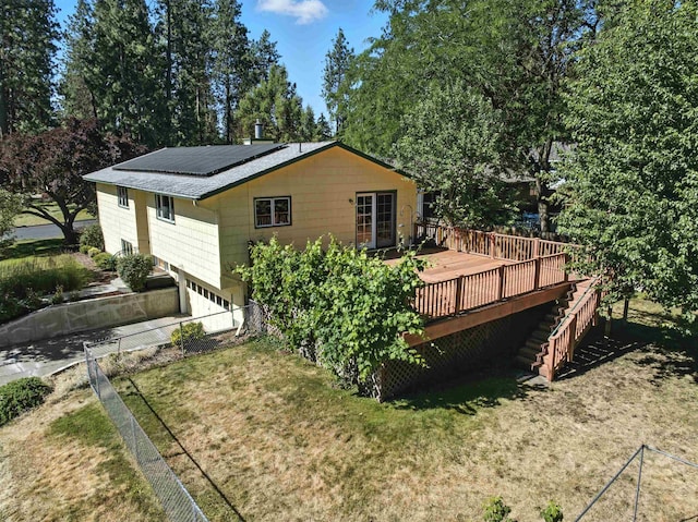 3832 S Cook St, Spokane, WA 99223 - rear view of house featuring stairway, a wooden deck, solar panels, and a lawn