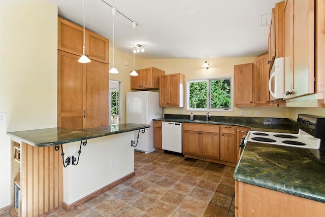 3832 S Cook St, Spokane, WA 99223 - kitchen featuring white appliances, pendant lighting, track lighting, vaulted ceiling, and stone finish flooring
