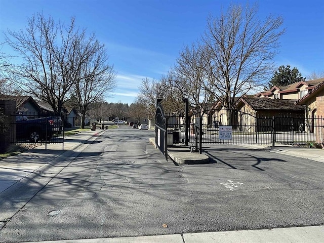 3714 S Alder Cir, Spokane, WA 99223 - view of asphalt street with sidewalks, curbs, a gate, and a residential view