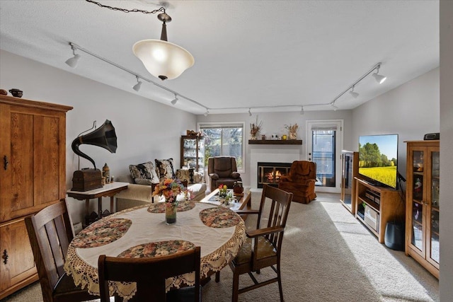 3714 S Alder Cir, Spokane, WA 99223 - dining room featuring track lighting, light colored carpet, and a glass covered fireplace