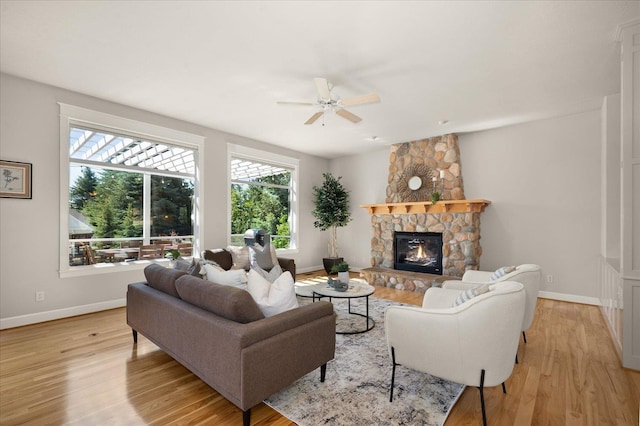 5614 N Thierman Rd, Spokane, WA 99217 - living room with plenty of natural light, light wood-style floors, a ceiling fan, and a stone fireplace