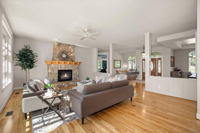 5614 N Thierman Rd, Spokane, WA 99217 - living area featuring light wood-type flooring, a ceiling fan, and a stone fireplace