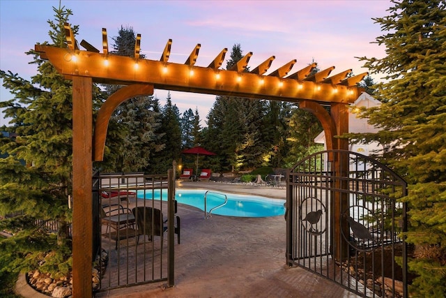 5614 N Thierman Rd, Spokane, WA 99217 - pool at dusk featuring a patio and a pergola