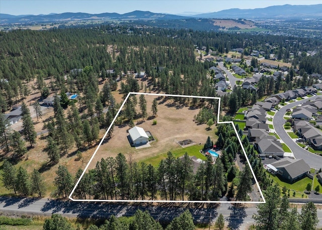5614 N Thierman Rd, Spokane, WA 99217 - aerial overview of property's location featuring a mountain backdrop and property boundaries highlighted