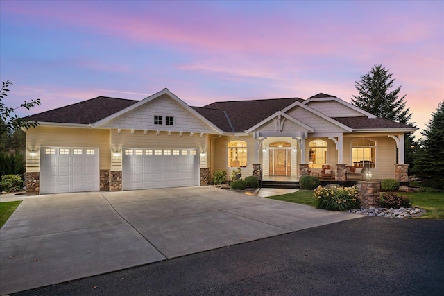 5614 N Thierman Rd, Spokane, WA 99217 - craftsman inspired home with stone siding, covered porch, a garage, driveway, and roof with shingles