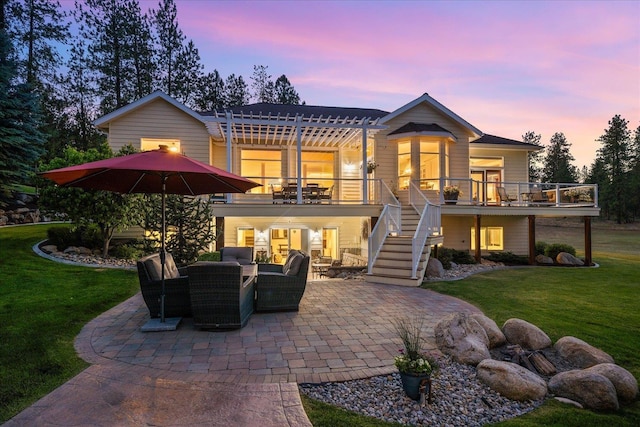 5614 N Thierman Rd, Spokane, WA 99217 - back of property at dusk featuring outdoor lounge area, a patio, a yard, and stairs