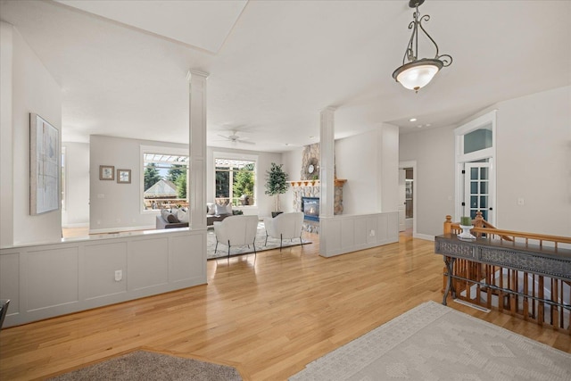5614 N Thierman Rd, Spokane, WA 99217 - living room with ornate columns, wood finished floors, a ceiling fan, and a fireplace
