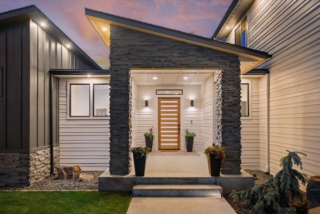 5257 S Falcon Point Ct, Spokane, WA 99224 - exterior entry at dusk featuring board and batten siding and stone siding