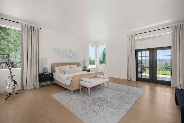 5257 S Falcon Point Ct, Spokane, WA 99224 - bedroom featuring access to exterior, light wood-type flooring, and french doors