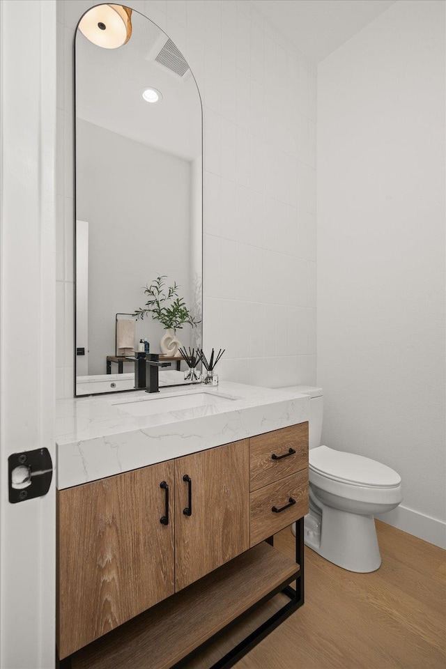 5257 S Falcon Point Ct, Spokane, WA 99224 - half bathroom featuring vanity and wood finished floors
