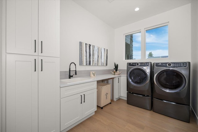 5257 S Falcon Point Ct, Spokane, WA 99224 - laundry area featuring washing machine and dryer, cabinet space, light wood-style flooring, and recessed lighting