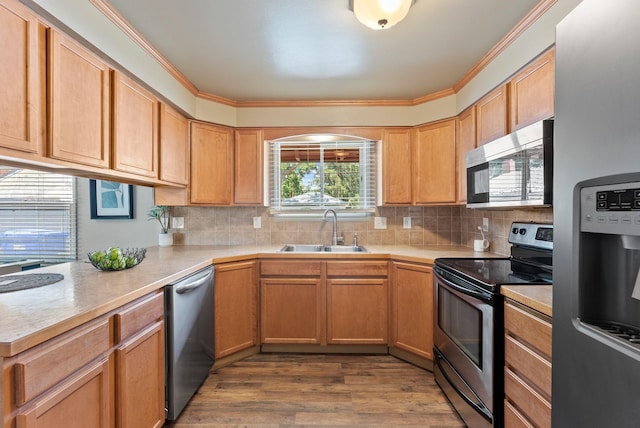 12911 E Desmet Ave, Spokane, WA 99216 - kitchen with stainless steel appliances, light countertops, backsplash, wood finished floors, and crown molding