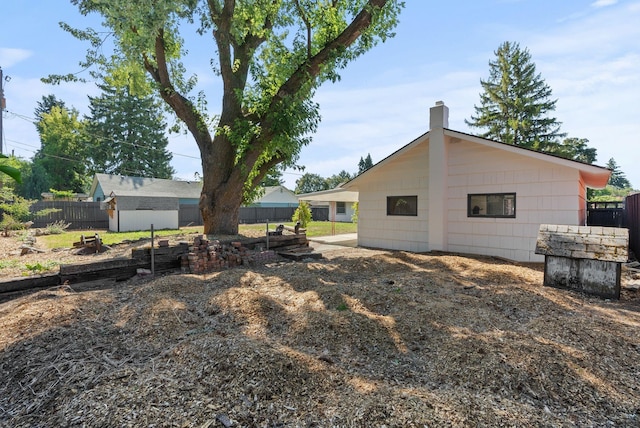 12911 E Desmet Ave, Spokane, WA 99216 - rear view of property featuring a chimney and an outbuilding