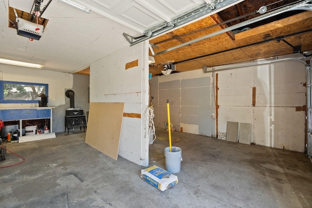 12911 E Desmet Ave, Spokane, WA 99216 - garage featuring a garage door opener and a wood stove