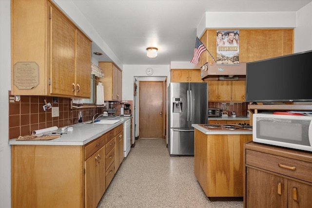11322 E 18th Ave, Spokane, WA 99206 - kitchen with white appliances, backsplash, light countertops, and brown cabinetry