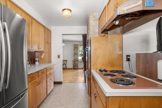 11322 E 18th Ave, Spokane, WA 99206 - kitchen with stainless steel appliances, light countertops, under cabinet range hood, tasteful backsplash, and dark aggregate flooring