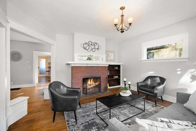 1518 W 6th Ave, Spokane, WA 99204 - living area with a chandelier, wood finished floors, and a brick fireplace