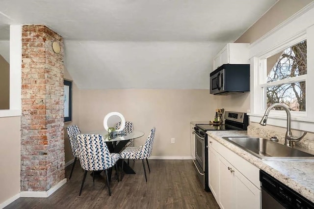 1518 W 6th Ave, Spokane, WA 99204 - kitchen with stainless steel appliances, lofted ceiling, dark wood-type flooring, white cabinets, and decorative columns