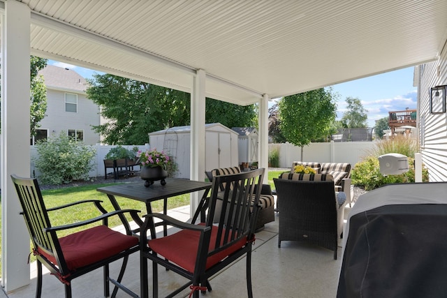 1611 W Tieton Ave, Spokane, WA 99208 - fenced backyard featuring a storage unit, a grill, outdoor dining area, a patio area, and an outdoor hangout area