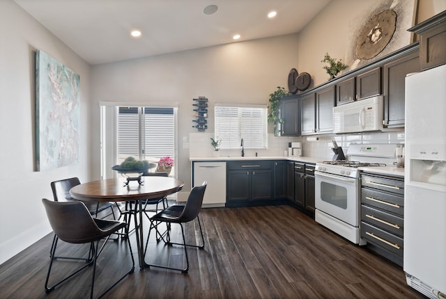 1611 W Tieton Ave, Spokane, WA 99208 - kitchen with white appliances, dark wood-type flooring, light countertops, tasteful backsplash, and recessed lighting