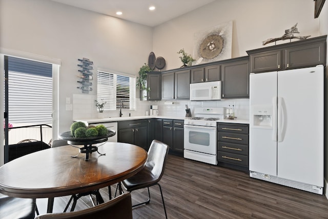 1611 W Tieton Ave, Spokane, WA 99208 - kitchen featuring white appliances, a high ceiling, light countertops, dark wood finished floors, and recessed lighting