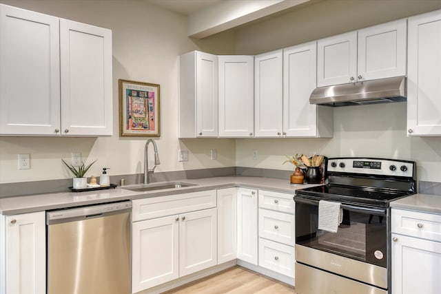 4907 E 6th Avenue 4909E 6Th Ave, Spokane Valley, WA 99212 - kitchen with stainless steel appliances, under cabinet range hood, and white cabinets