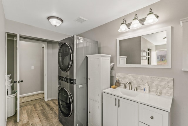 9906 E 17th Ln, Spokane Valley, WA 99206 - laundry area with stacked washer and clothes dryer and wood finished floors