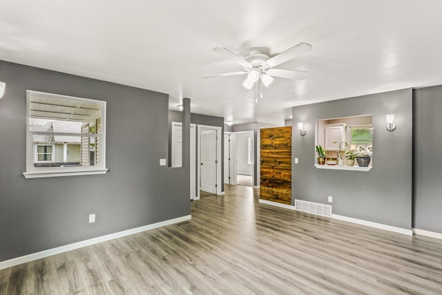 9906 E 17th Ln, Spokane Valley, WA 99206 - unfurnished living room with a ceiling fan, plenty of natural light, and wood finished floors