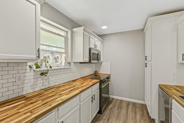 9906 E 17th Ln, Spokane Valley, WA 99206 - kitchen featuring wooden counters, stainless steel appliances, wood finished floors, white cabinetry, and decorative backsplash