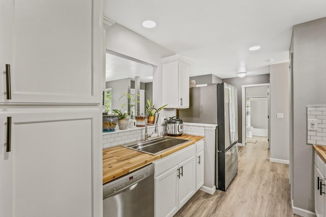 9906 E 17th Ln, Spokane Valley, WA 99206 - kitchen featuring stainless steel appliances, light wood finished floors, white cabinets, and butcher block counters