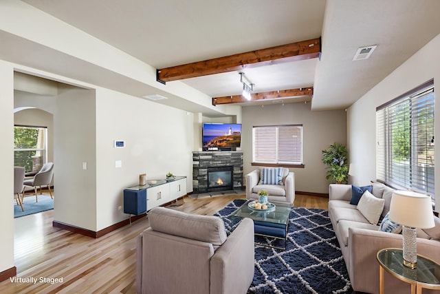 16319 E Whirlaway Ln, Veradale, WA 99037 - living area featuring a fireplace, light wood finished floors, beam ceiling, and arched walkways