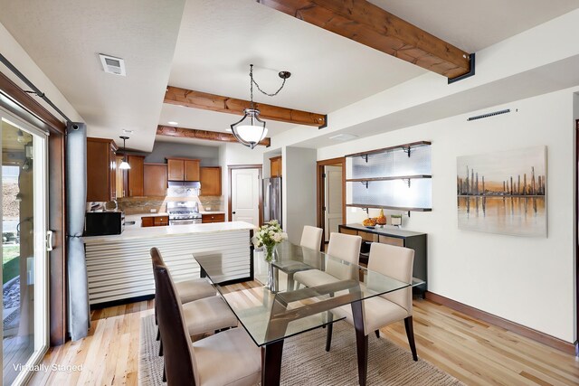 16319 E Whirlaway Ln, Veradale, WA 99037 - dining area with beamed ceiling and light wood-type flooring
