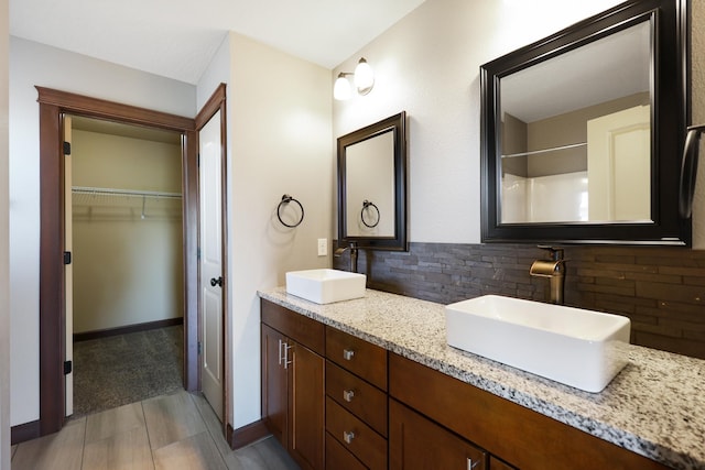 16319 E Whirlaway Ln, Veradale, WA 99037 - full bathroom featuring decorative backsplash, double vanity, and a walk in closet