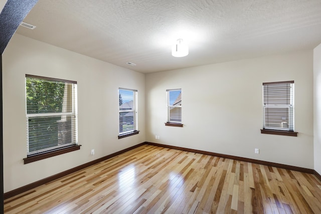 16319 E Whirlaway Ln, Veradale, WA 99037 - spare room featuring light wood-style flooring and a textured ceiling