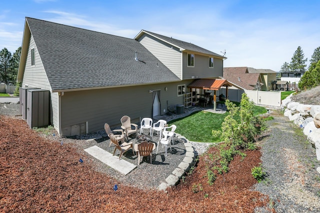 16319 E Whirlaway Ln, Veradale, WA 99037 - back of property featuring an outdoor fire pit, a patio, a fenced backyard, and roof with shingles