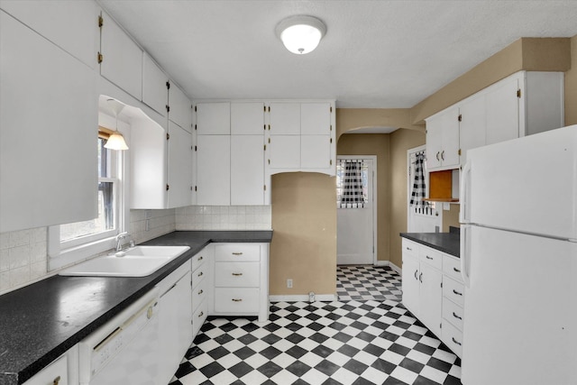 1728 W Spofford Ave, Spokane, WA 99205 - kitchen with white appliances, light floors, dark countertops, and decorative backsplash