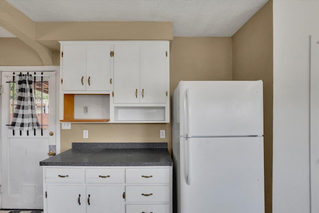 1728 W Spofford Ave, Spokane, WA 99205 - kitchen with freestanding refrigerator, dark countertops, open shelves, and white cabinets