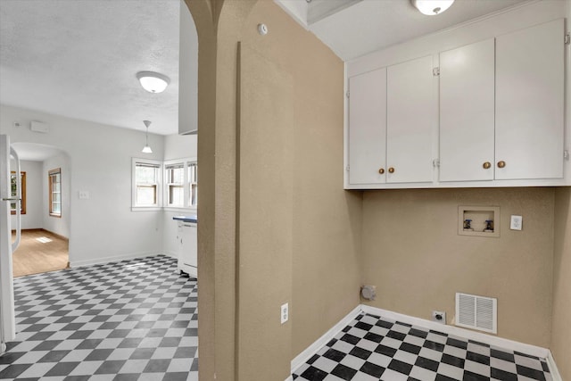 1728 W Spofford Ave, Spokane, WA 99205 - washroom with cabinet space, arched walkways, tile patterned floors, hookup for a washing machine, and electric dryer hookup