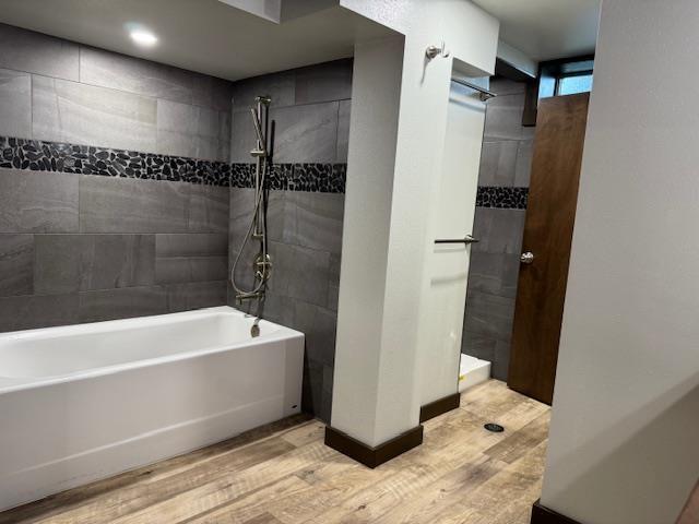 6412 N Fotheringham St, Spokane, WA 99208 - bathroom with wood finished floors and shower / washtub combination
