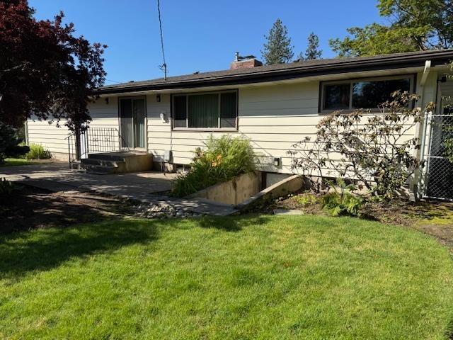 6412 N Fotheringham St, Spokane, WA 99208 - rear view of house with a chimney